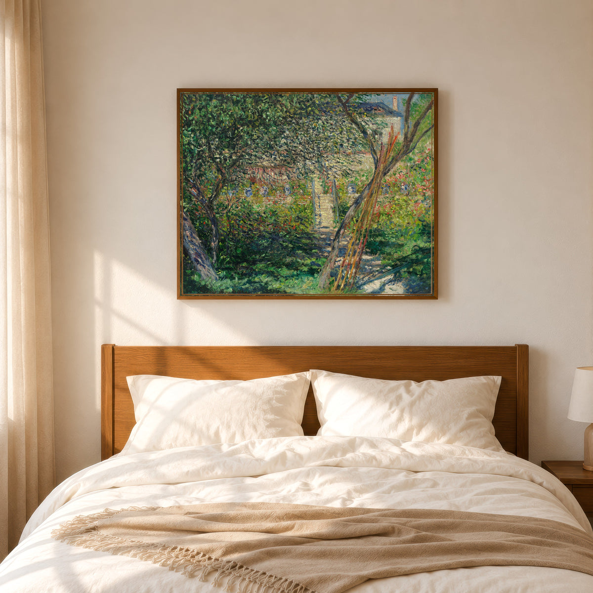 Framed art print of Garden at Vétheuil by Claude Monet, in a slim wood frame above a bed in a sunlit bedroom
