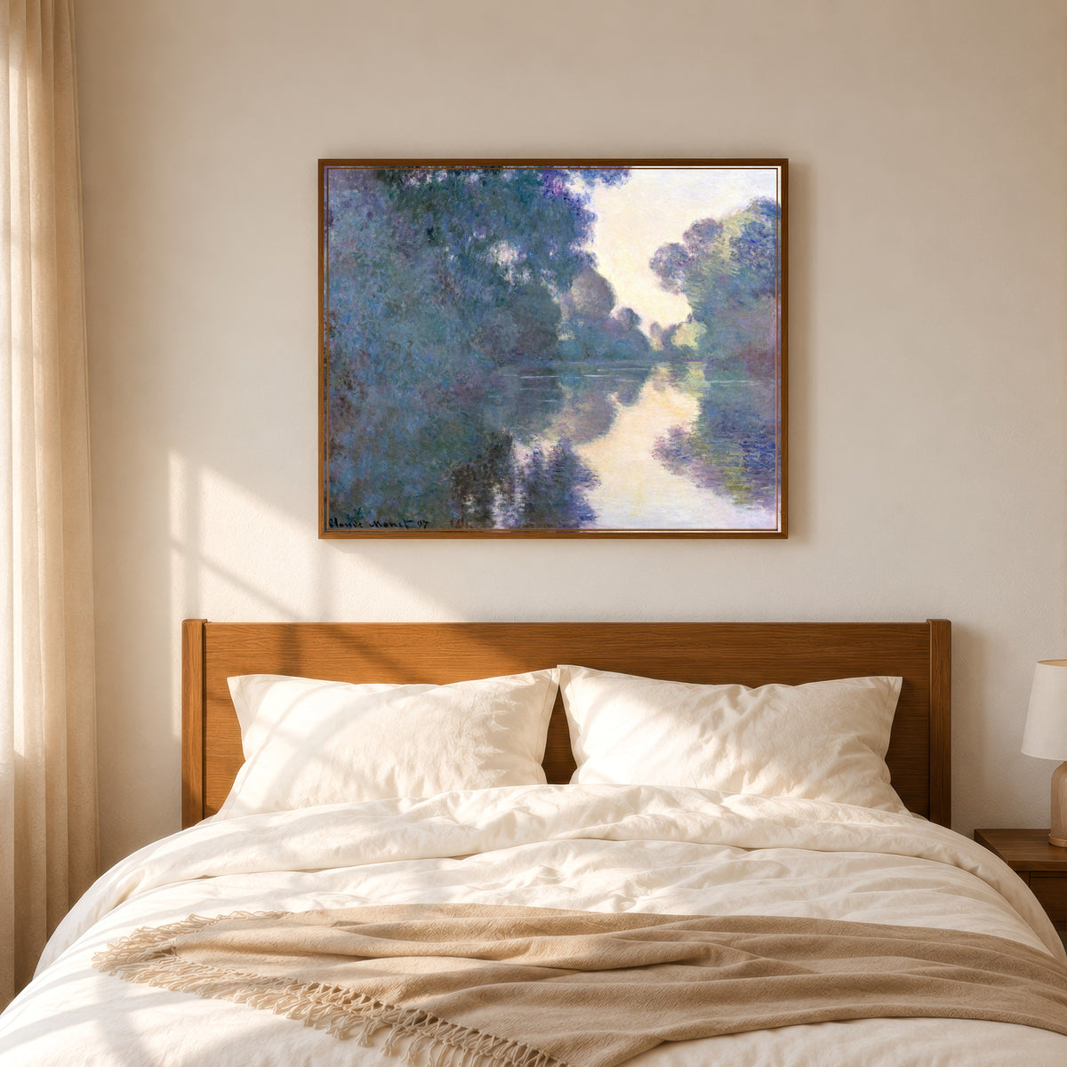 Framed art print of Morning on the Seine near Giverny by Claude Monet, in a slim wood frame above a bed in a sunlit bedroom