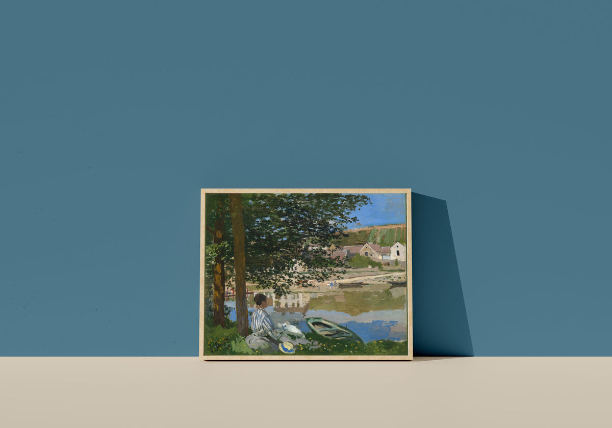 Framed art print of On the Bank of the Seine, Bennecourt by Claude Monet, in a light wood frame leaning on a blue wall