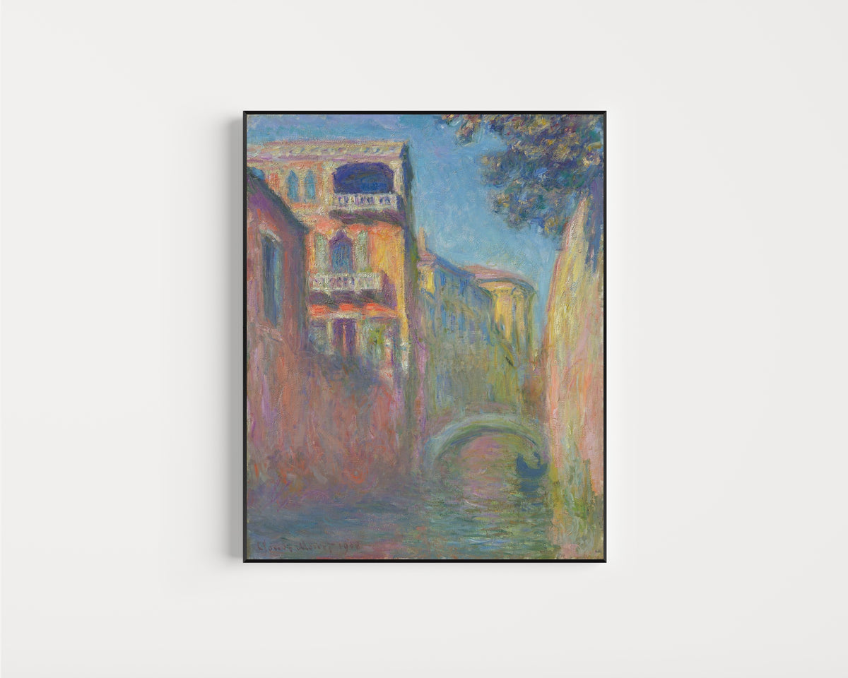 Framed art print of Rio della Salute by Claude Monet, in a slim black frame on a plain white wall