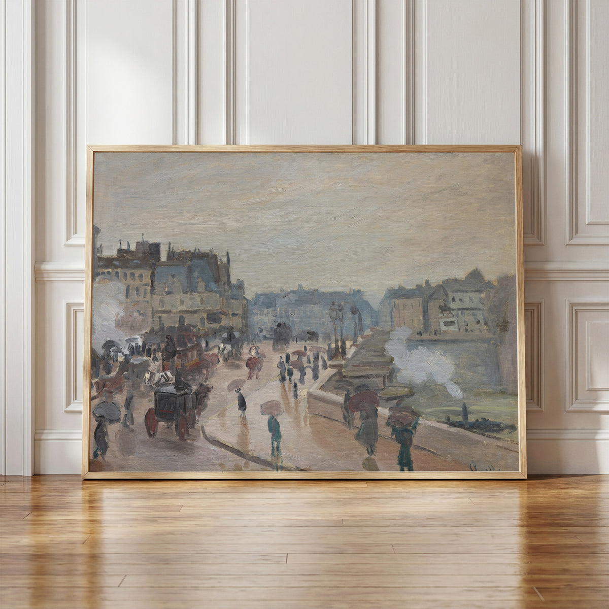 Framed art print of The Pont Neuf by Claude Monet, in a light wood frame leaning against a panelled white wall
