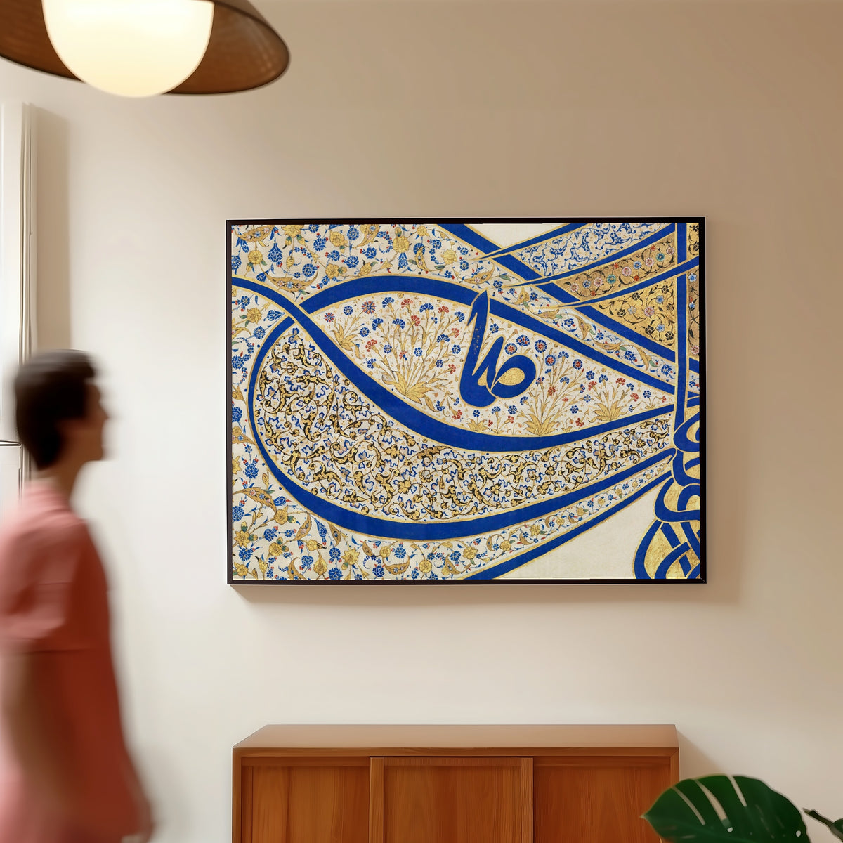 Framed art print of Tughra of Sultan Suleiman the Magnificent (16th Ct. Detail) by Sultan Suleiman, in a slim black frame on a warm wall in a sunlit room