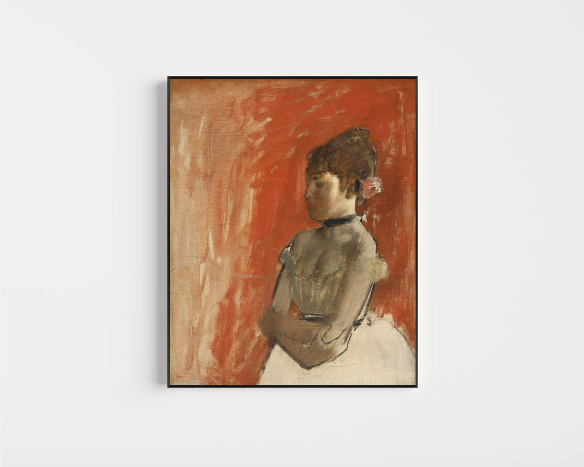 Framed art print of Ballet Dancer with Arms Crossed by Edgar Degas, in a slim black frame on a plain white wall