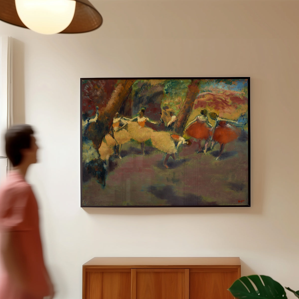 Framed art print of Before the Performance by Edgar Degas, in a slim black frame on a warm wall in a sunlit room