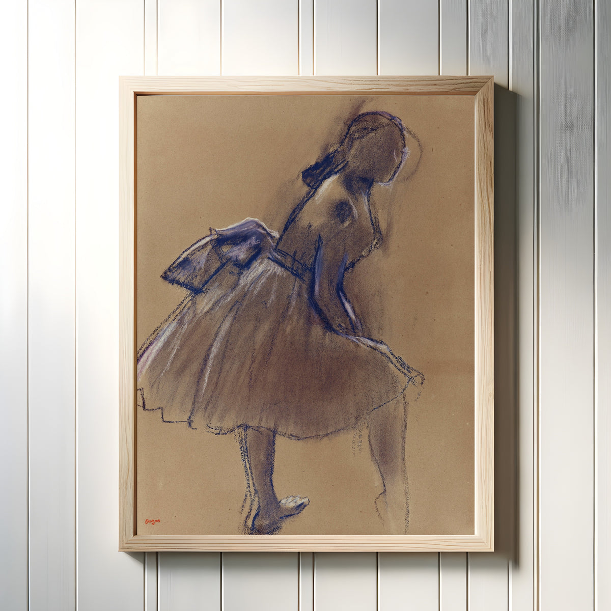 Framed art print of Danseuse debout, de profil by Edgar Degas, in a light wood frame on a white panelled wall