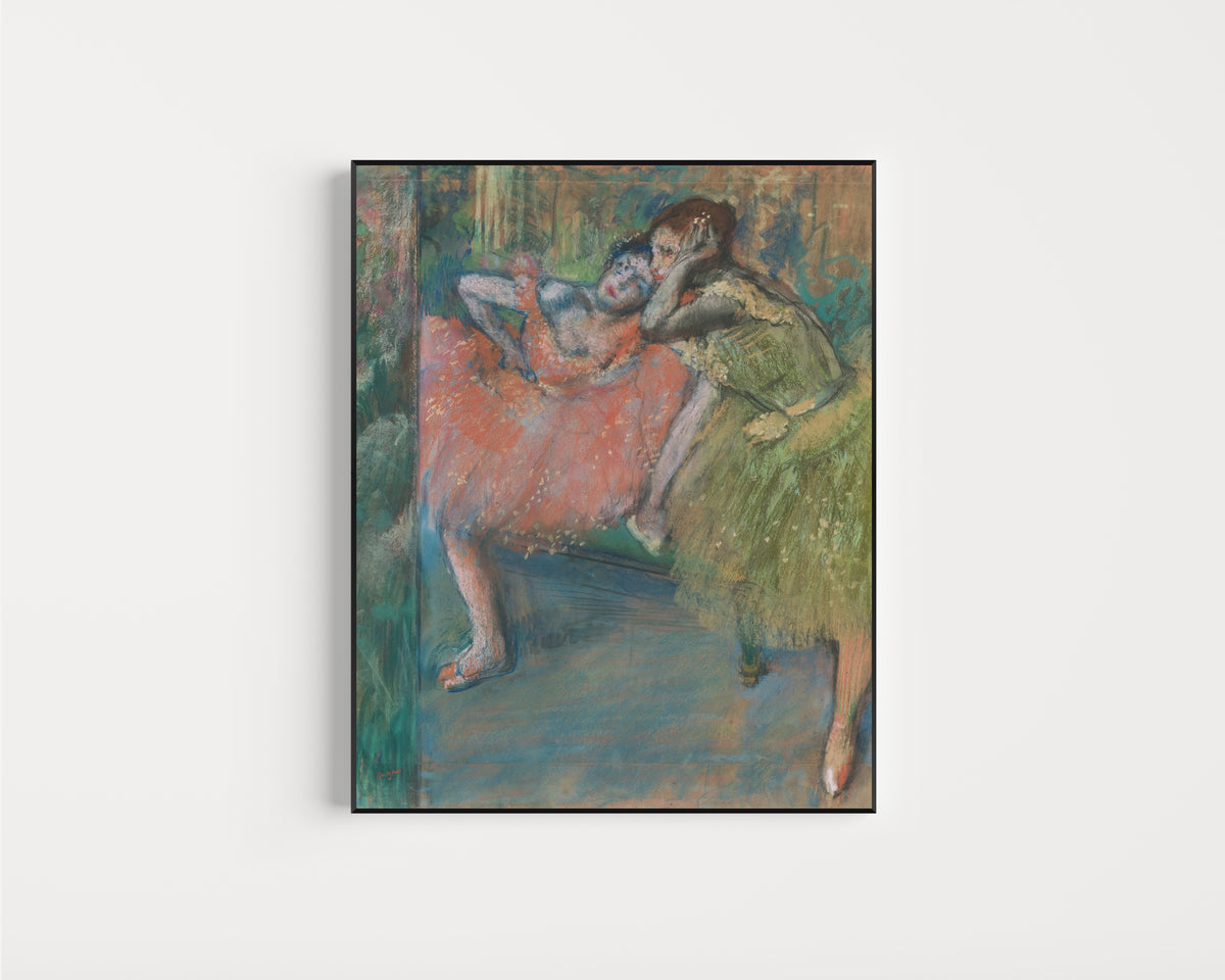 Framed art print of Danseuses au foyer by Edgar Degas, in a slim black frame on a plain white wall