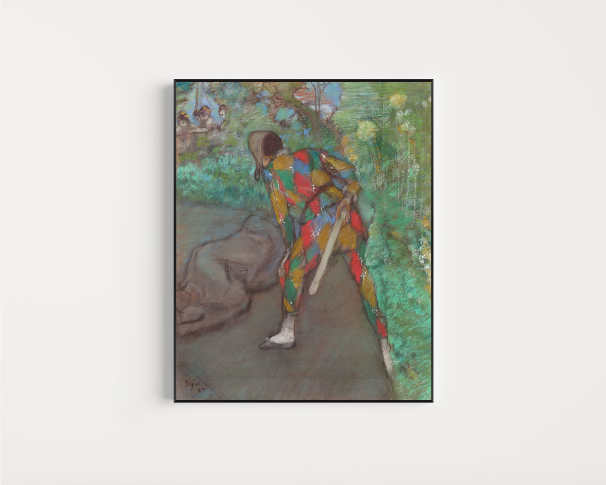 Framed art print of Harlequin by Edgar Degas, in a slim black frame on a plain white wall
