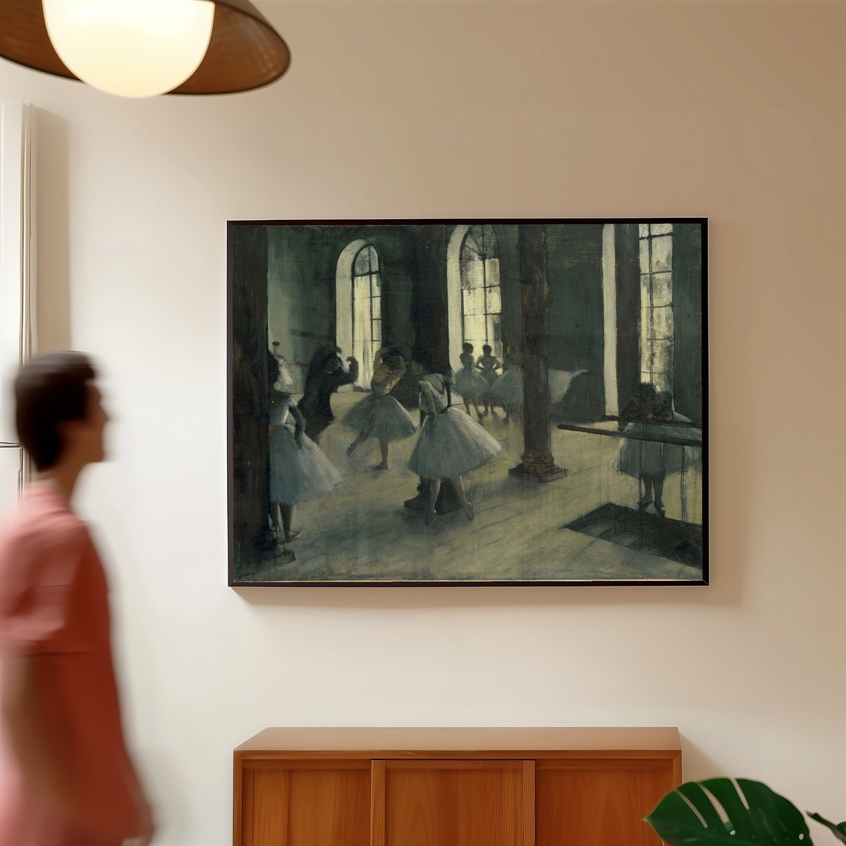 Framed art print of La Répétition au foyer de la danse by Edgar Degas, in a slim black frame on a warm wall in a sunlit room