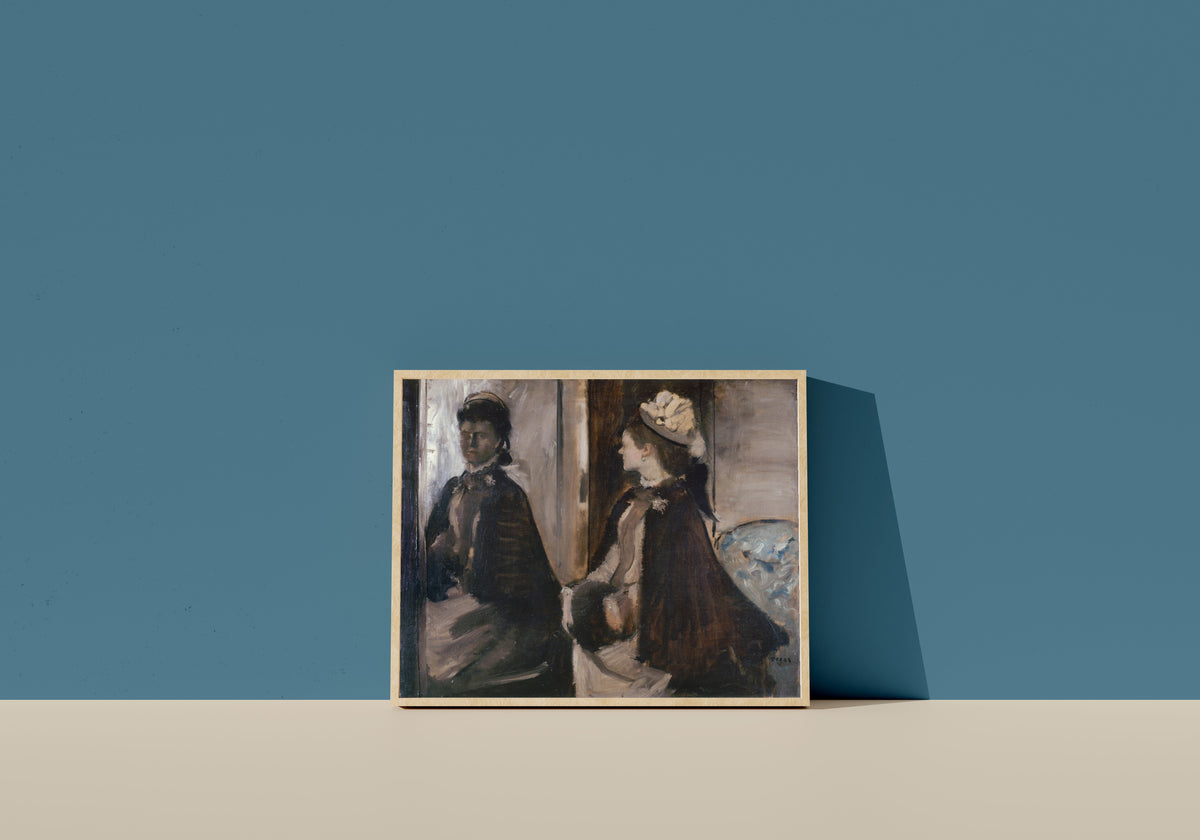 Framed art print of Mrs Jeantaud in the Mirror by Edgar Degas, in a light wood frame leaning on a blue wall