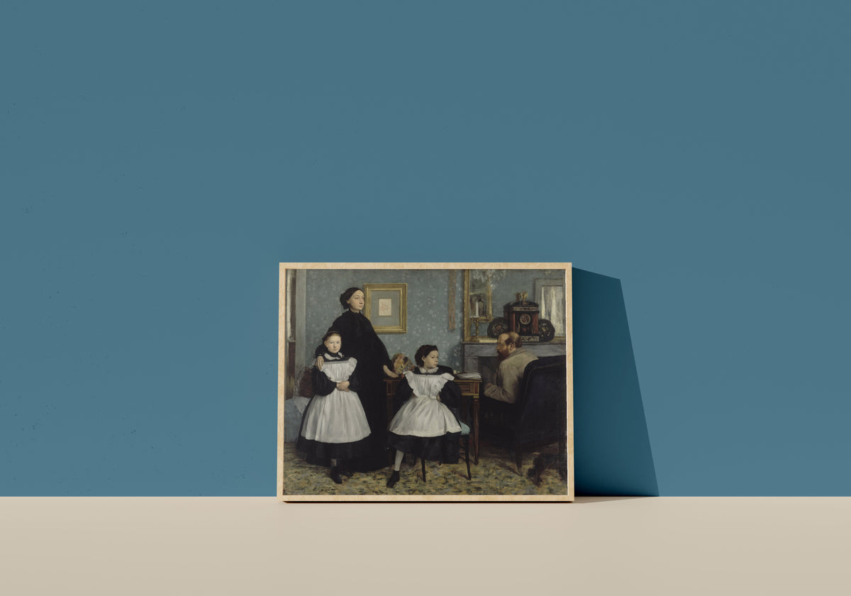 Framed art print of The Bellelli Family by Edgar Degas, in a light wood frame leaning on a blue wall
