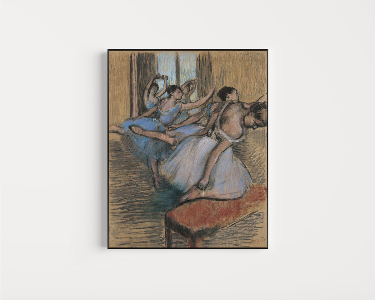 Framed art print of The Dancers (Red Bench) by Edgar Degas, in a slim black frame on a plain white wall