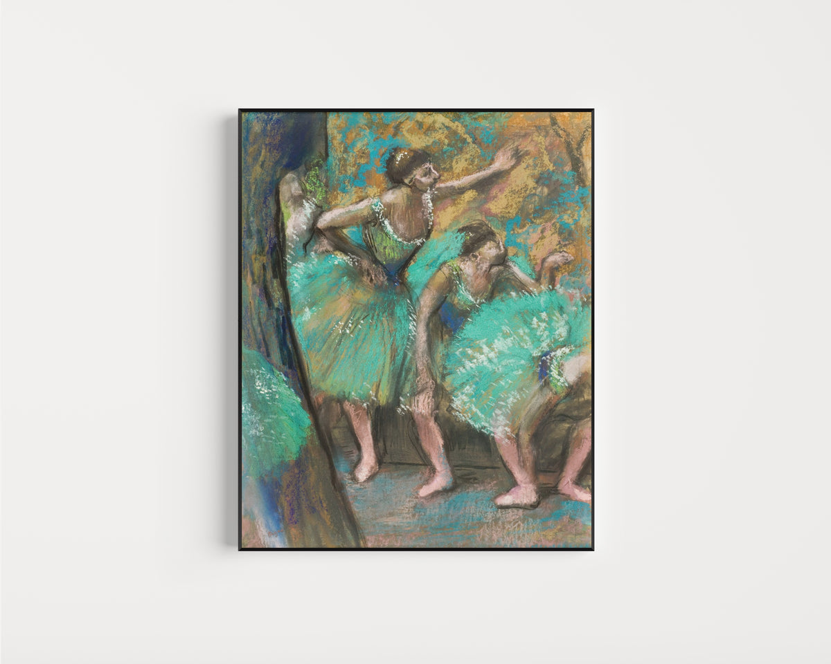 Framed art print of The Dancers (Turquoise Skirts) by Edgar Degas, in a slim black frame on a plain white wall