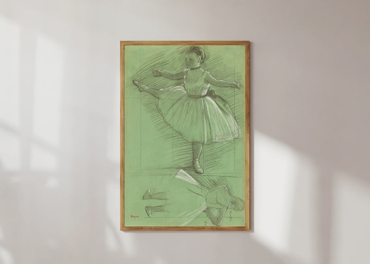 Framed art print of Two Studies of Dancers (Leg Raised to the Side) by Edgar Degas, in a light wood frame on a sunlit white wall