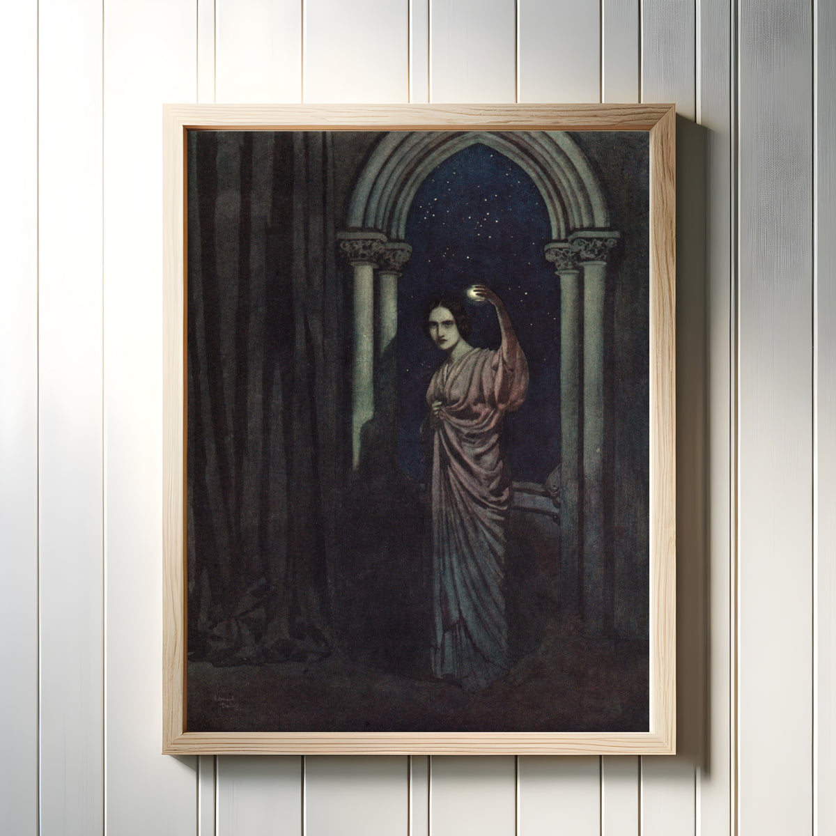 Framed art print of The Bells and Other Poems: To Helen by Edmund Dulac, in a light wood frame on a white panelled wall