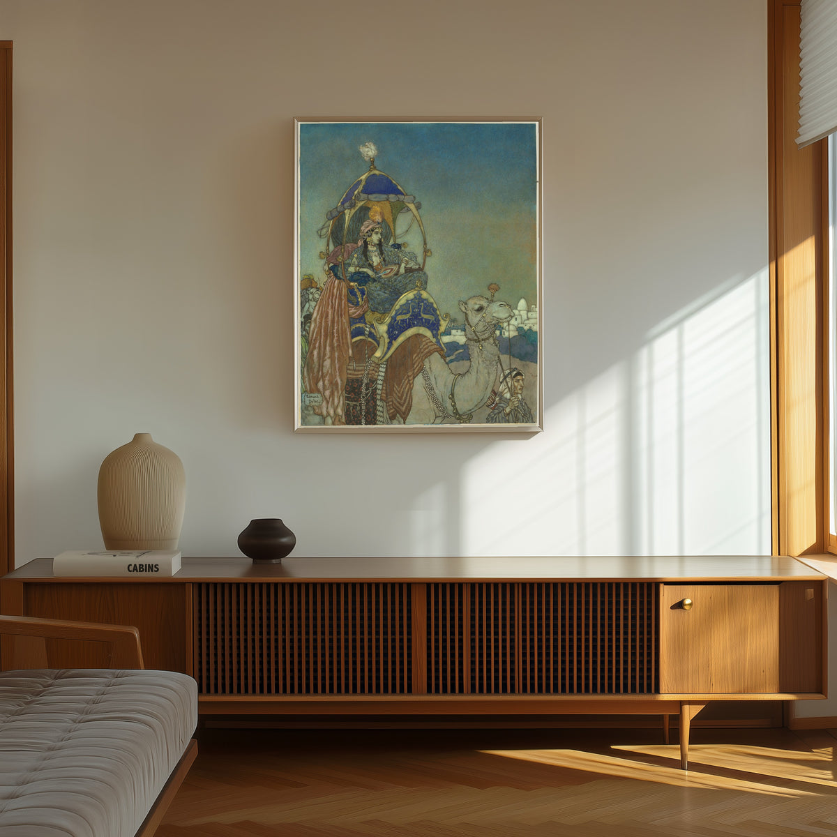 Framed art print of The Queen of Sheba by Edmund Dulac, in a thin light frame on a sunlit wall above a wooden sideboard
