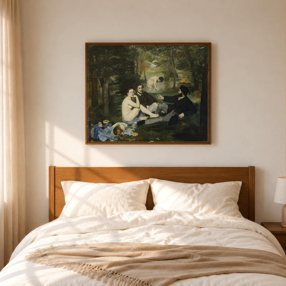 Framed art print of Luncheon on the Grass by Édouard Manet, in a slim wood frame above a bed in a sunlit bedroom