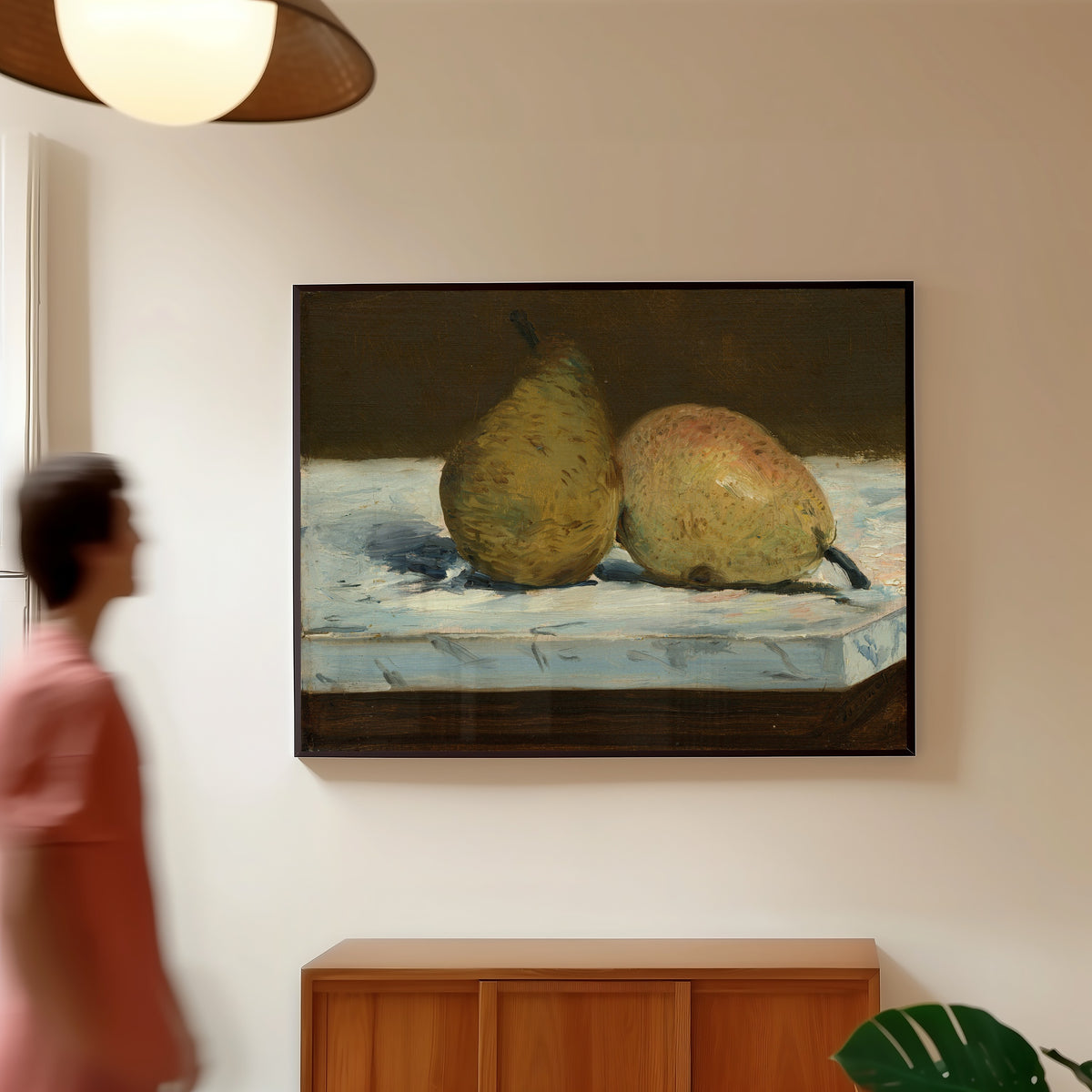 Framed art print of Pears by Édouard Manet, in a slim black frame on a warm wall in a sunlit room