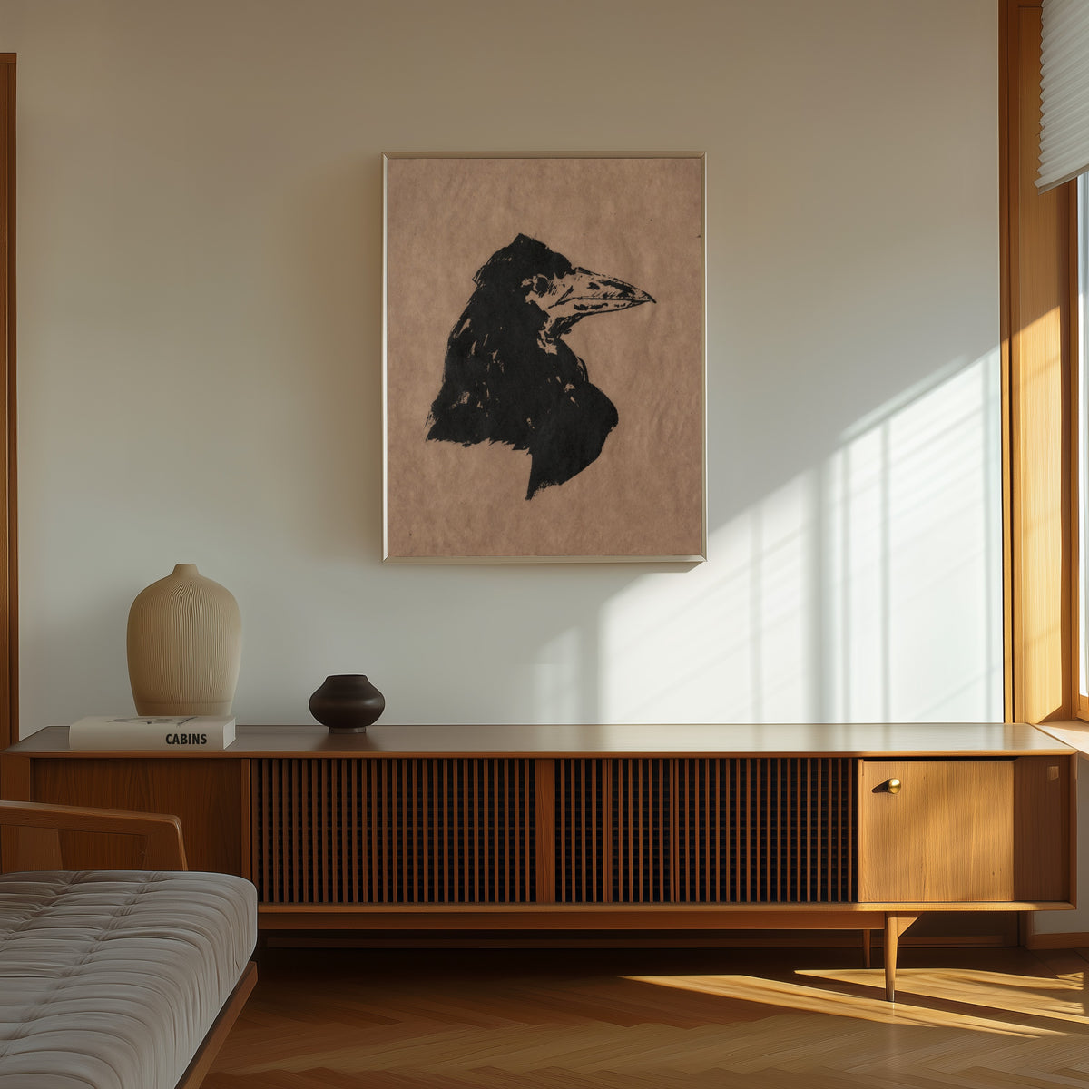 Framed art print of Raven's Head in Profile by Édouard Manet, in a thin light frame on a sunlit wall above a wooden sideboard