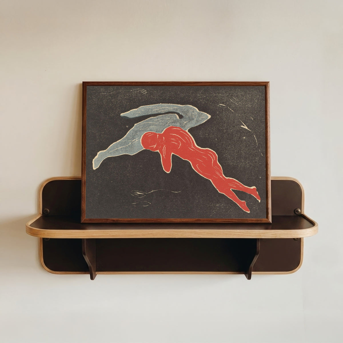 Framed art print of Encounter in Space by Edvard Munch, in a dark wood frame resting on a wall shelf