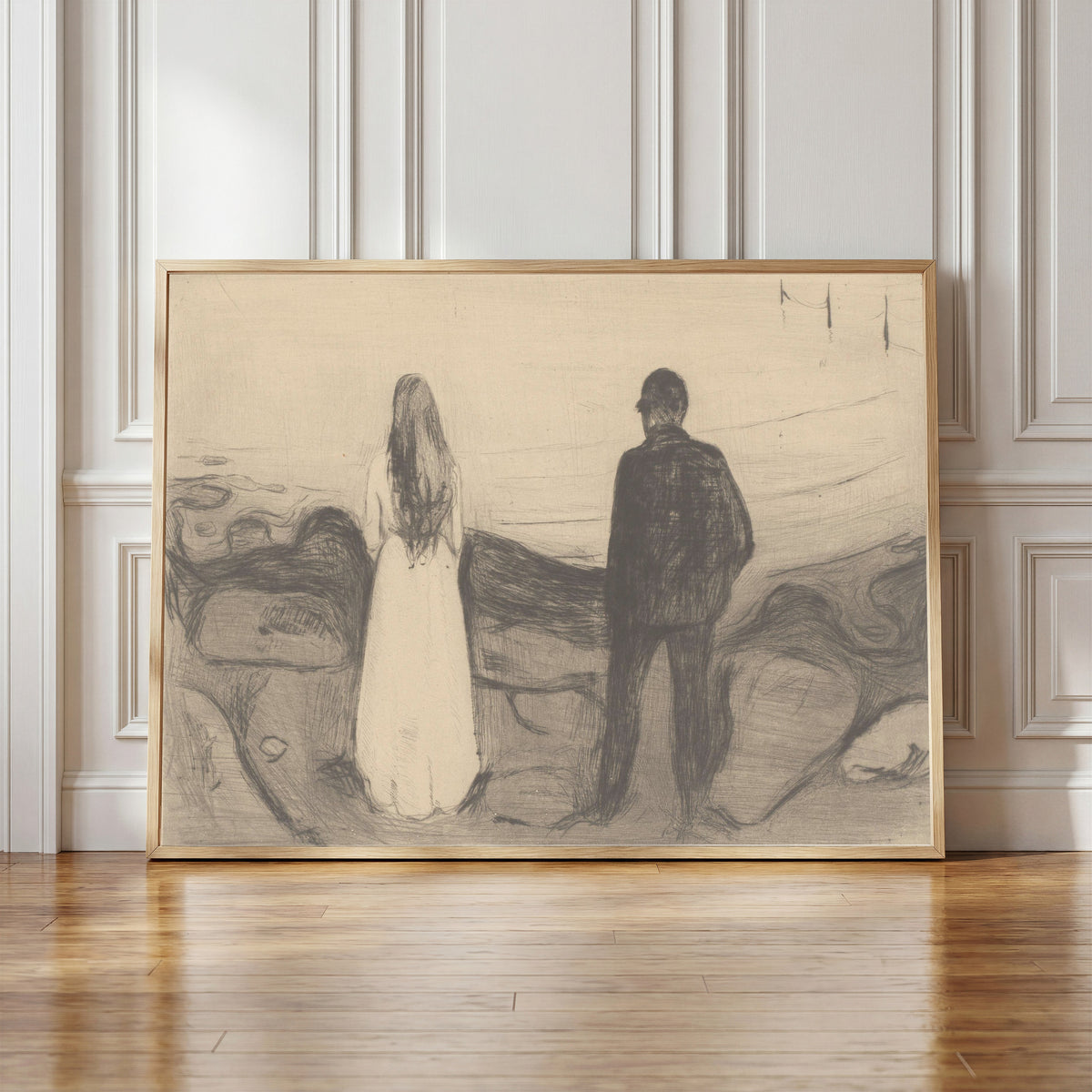 Framed art print of Two People (The Lonely Ones) by Edvard Munch, in a light wood frame leaning against a panelled white wall