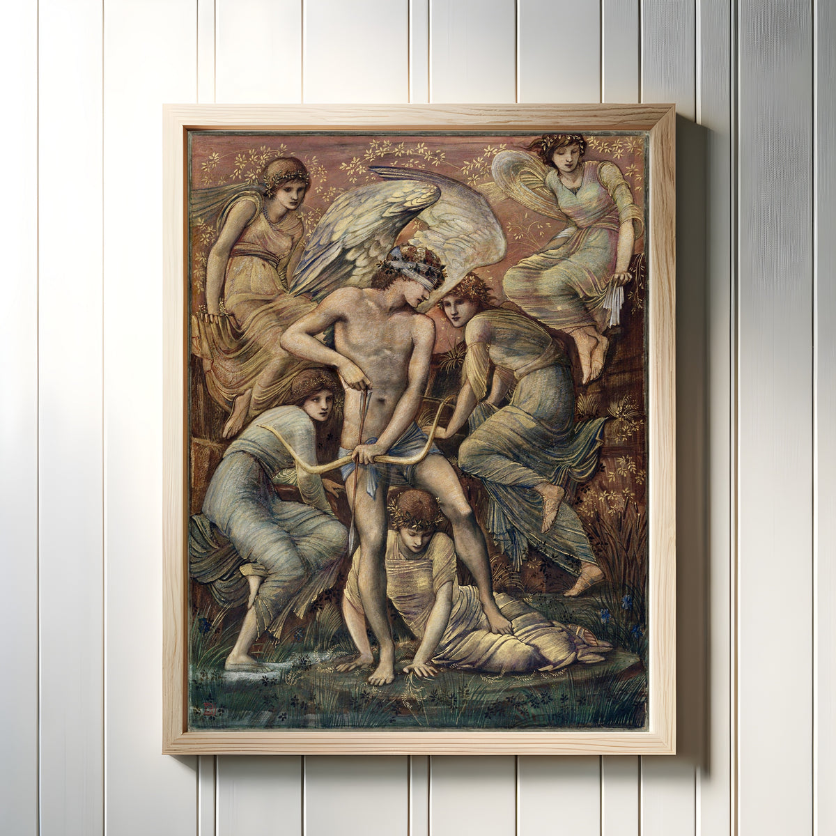 Framed art print of Cupid's Hunting Grounds by Edward Burne-Jones, in a light wood frame on a white panelled wall