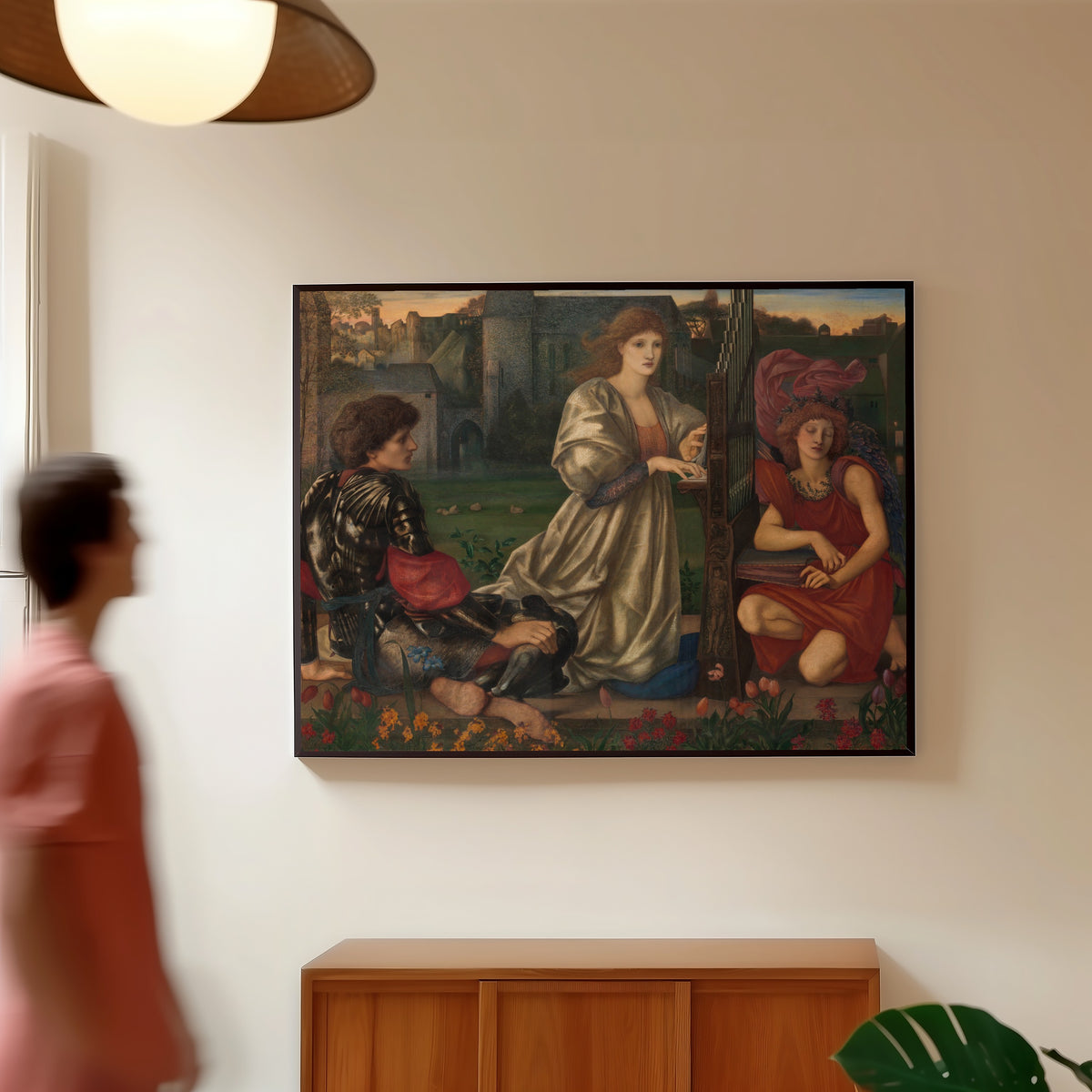 Framed art print of The Love Song by Edward Burne-Jones, in a slim black frame on a warm wall in a sunlit room