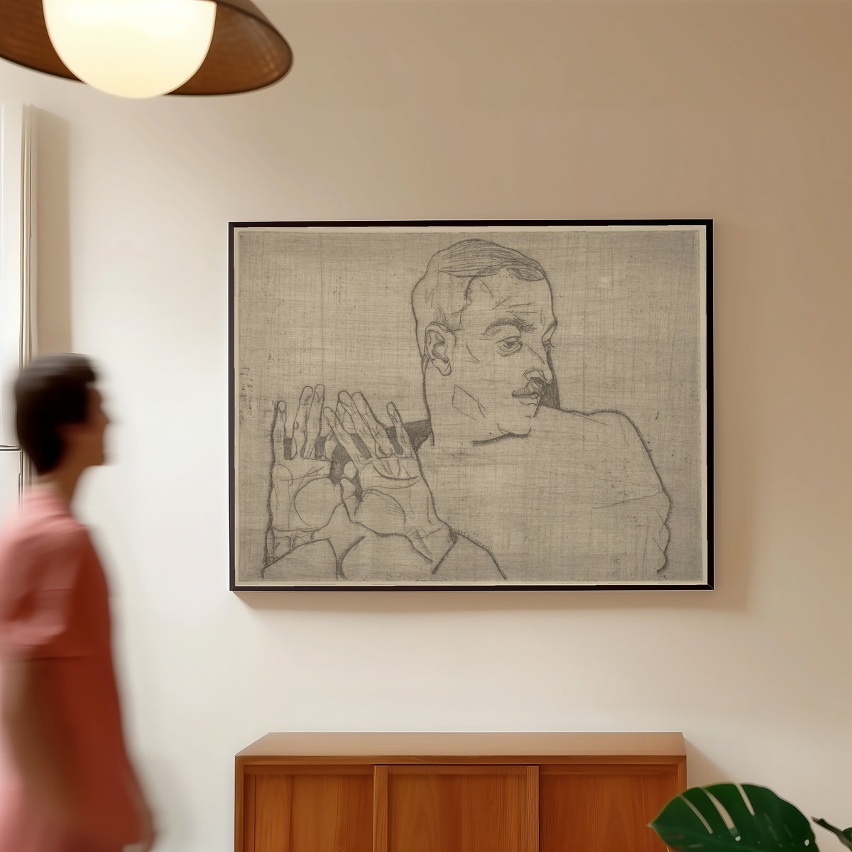 Framed art print of Portrait of Arthur Roessler by Egon Schiele, in a slim black frame on a warm wall in a sunlit room