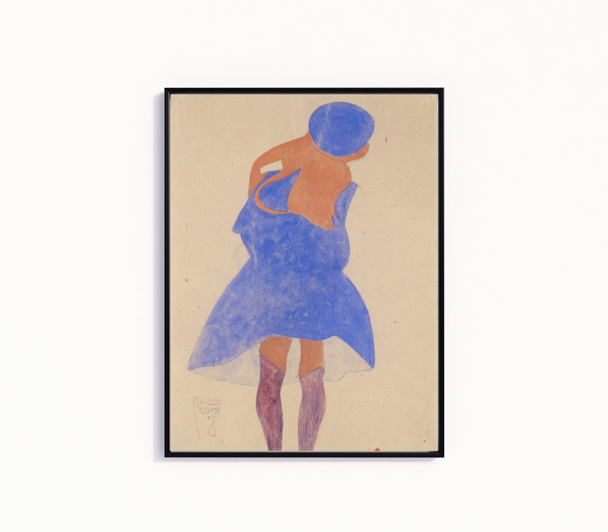 Framed art print of Standing Girl, Back View by Egon Schiele, in a slim black frame on a plain white wall