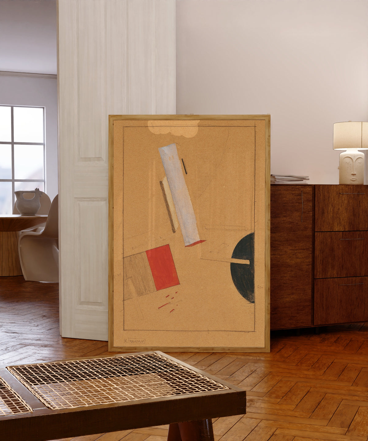 Framed art print of Proun Study by El Lissitzky, in a light wood frame leaning in a warm room with a parquet floor