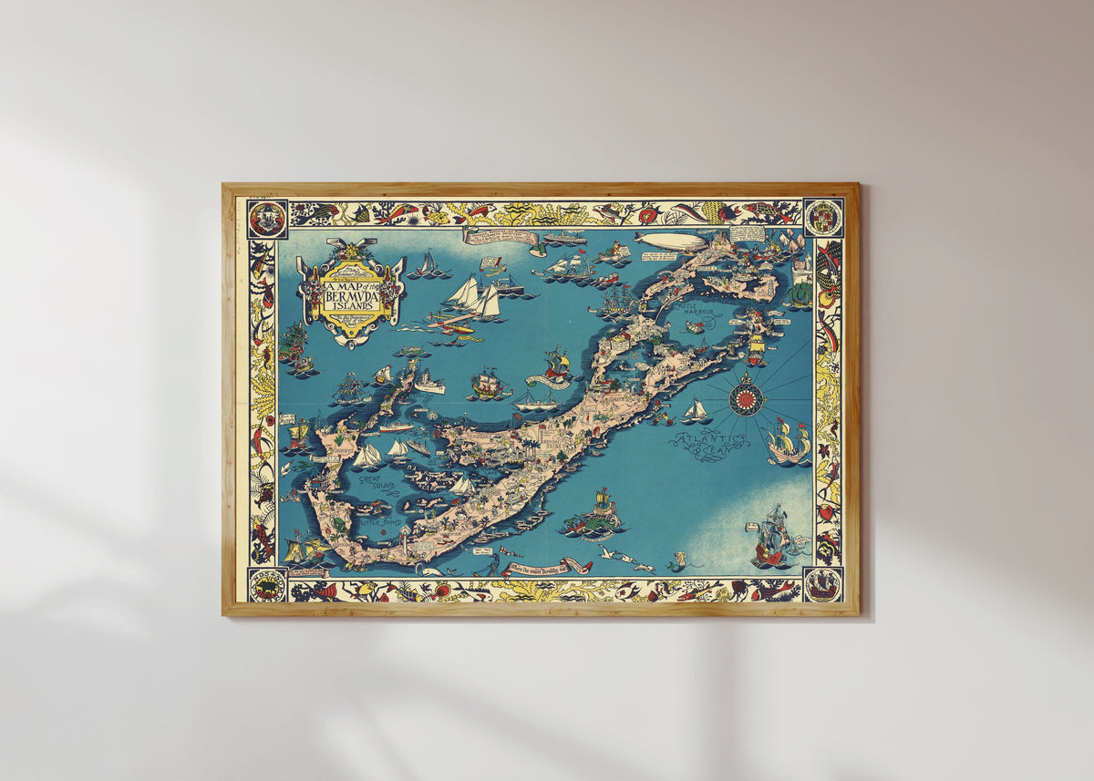 Framed art print of A Map of the Bermuda Islands by Elizabeth Shurtleff, in a light wood frame on a sunlit white wall