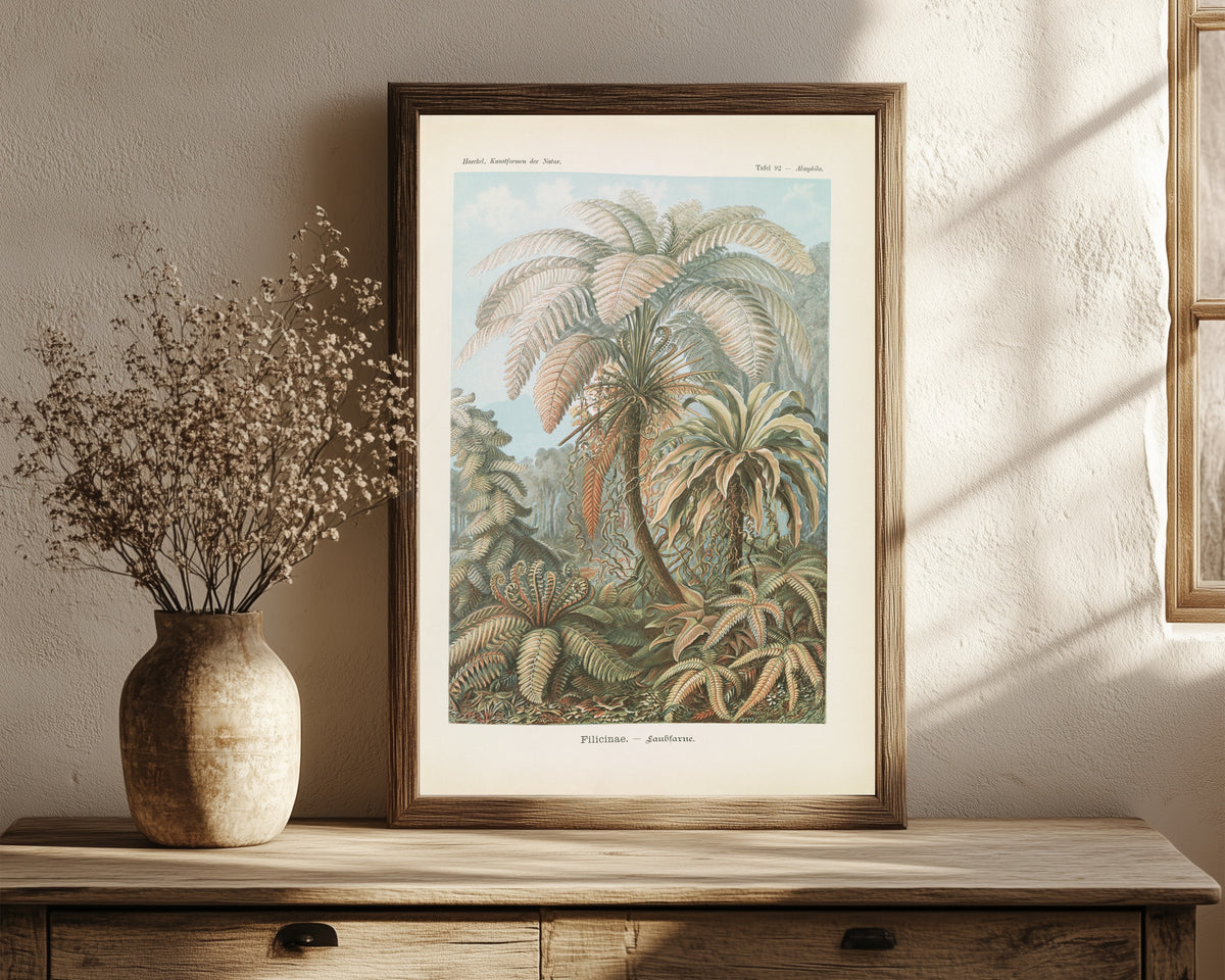 Framed art print of Kunstformen der Natur, Plate 92: Filicinae by Ernst Haeckel, in a dark wood frame leaning on a rustic console beside dried flowers