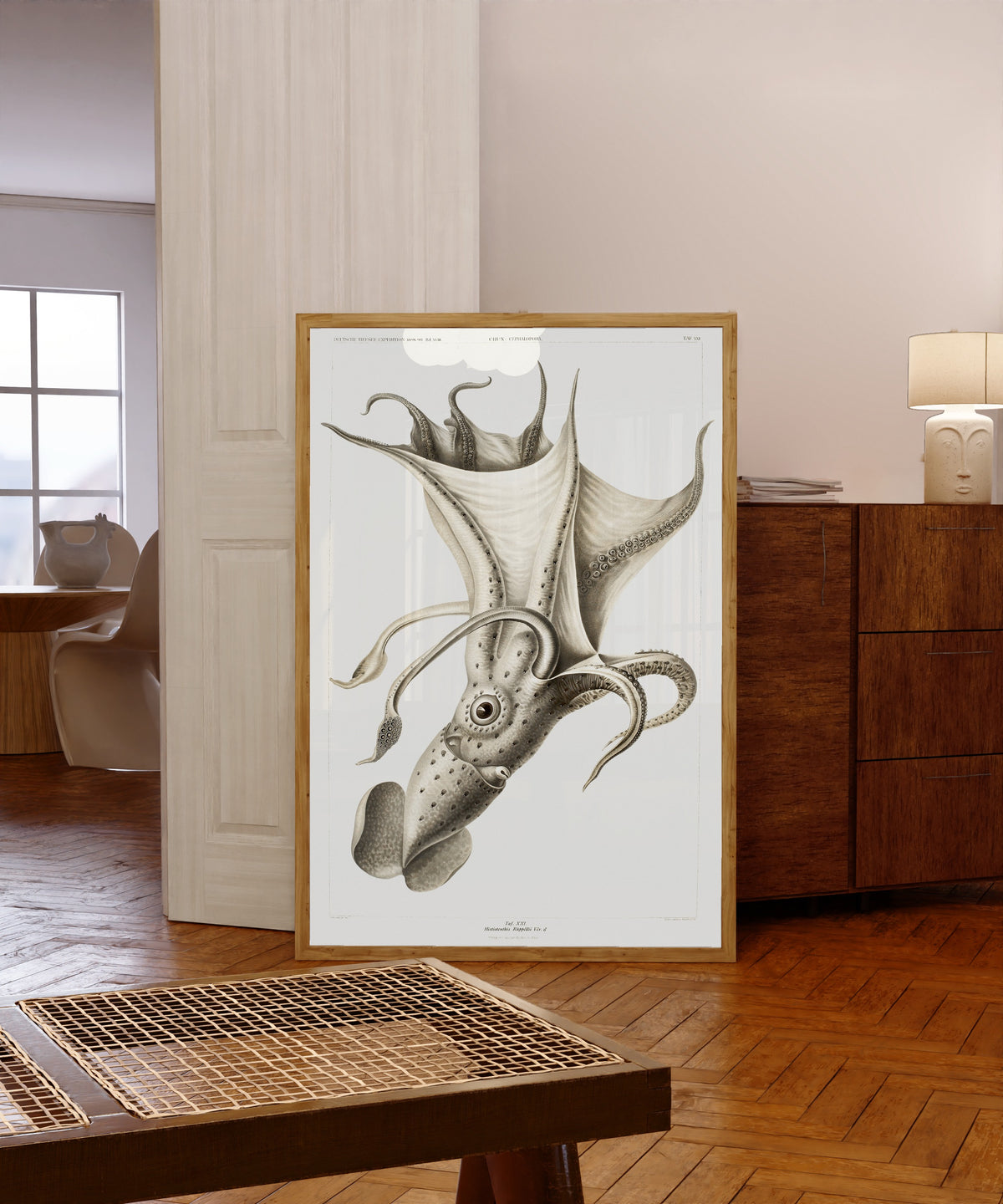 Framed art print of Histioteuthis rüppellii by Ewald Heinrich Rübsaamen, in a light wood frame leaning in a warm room with a parquet floor