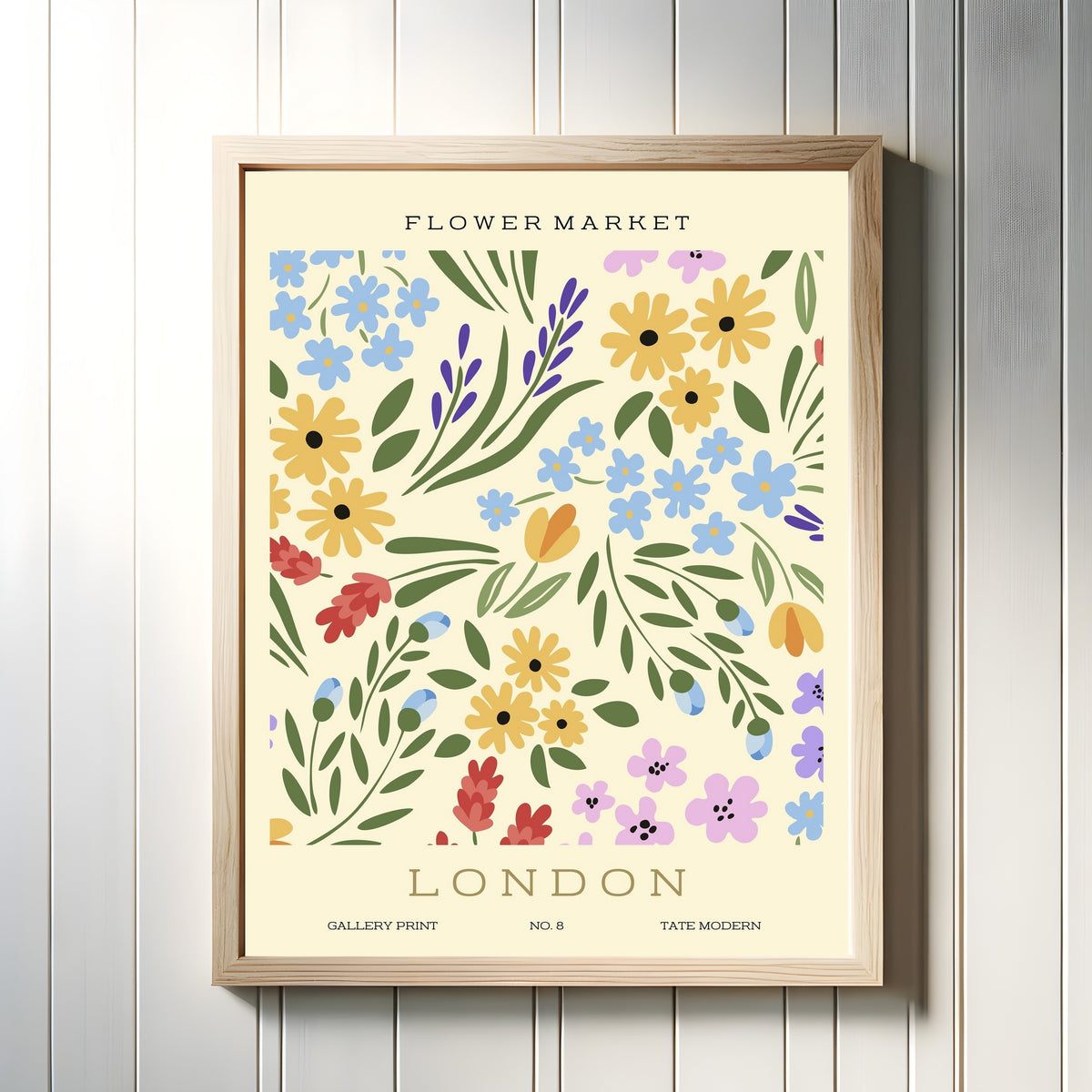 Framed art print of London by Original, in a light wood frame on a white panelled wall