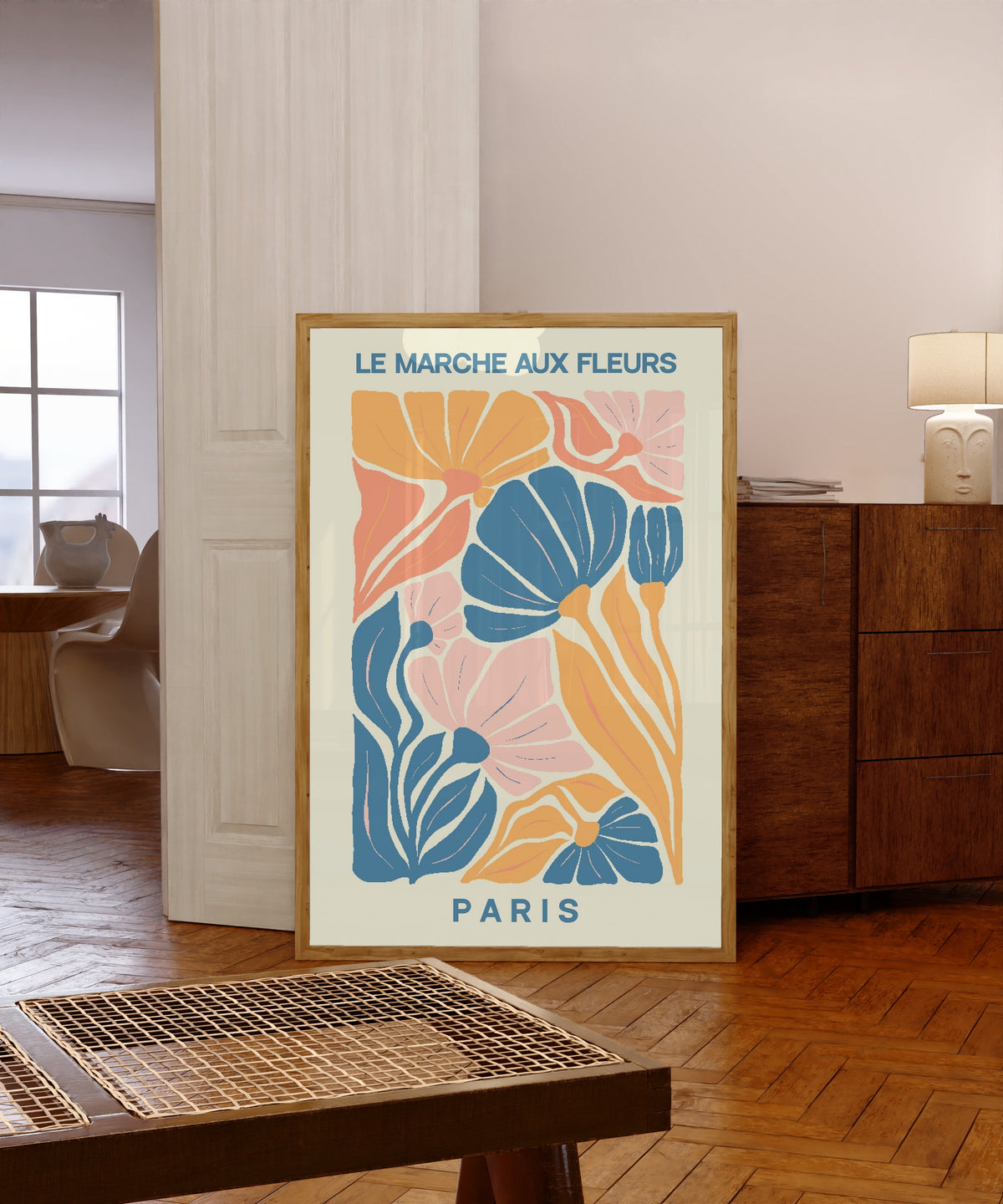 Framed art print of Paris by Original, in a light wood frame leaning in a warm room with a parquet floor