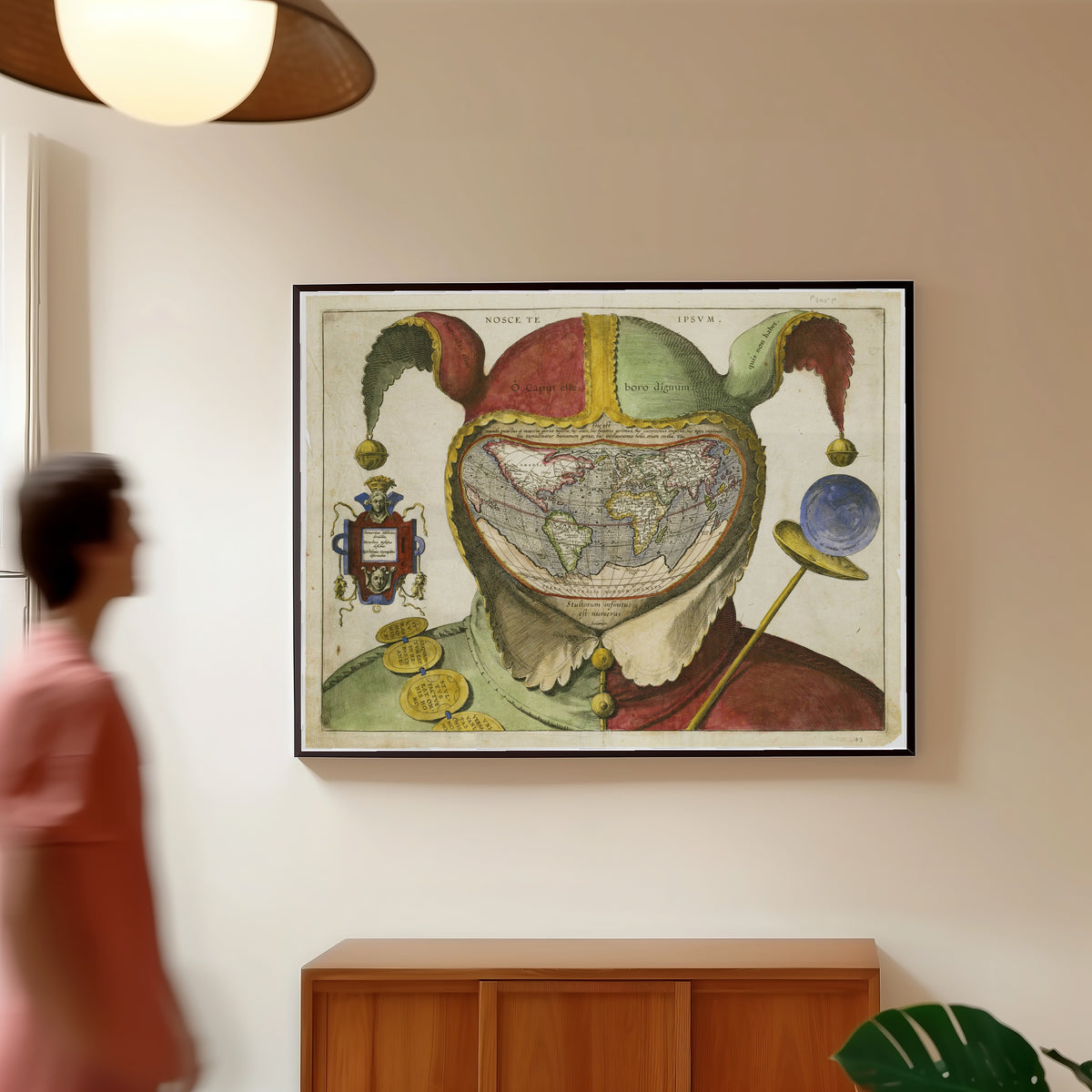 Framed art print of Fool's Cap Map of the World, in a slim black frame on a warm wall in a sunlit room