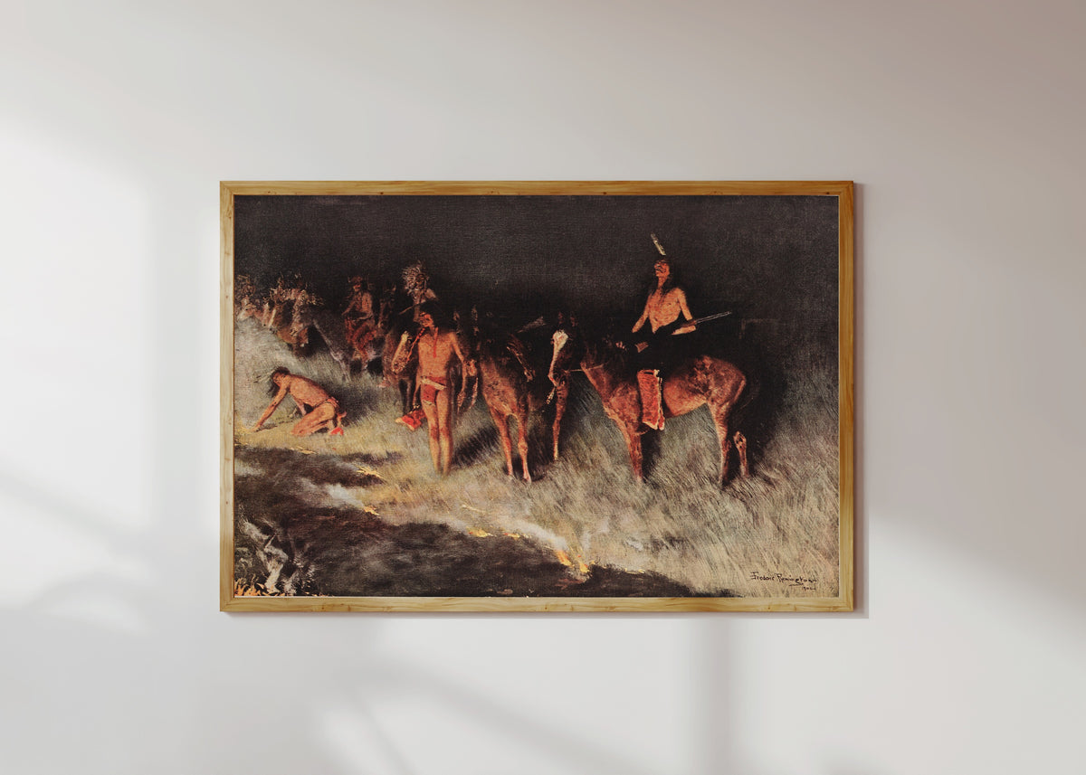 Framed art print of The Grass Fire by Frederic Remington, in a light wood frame on a sunlit white wall