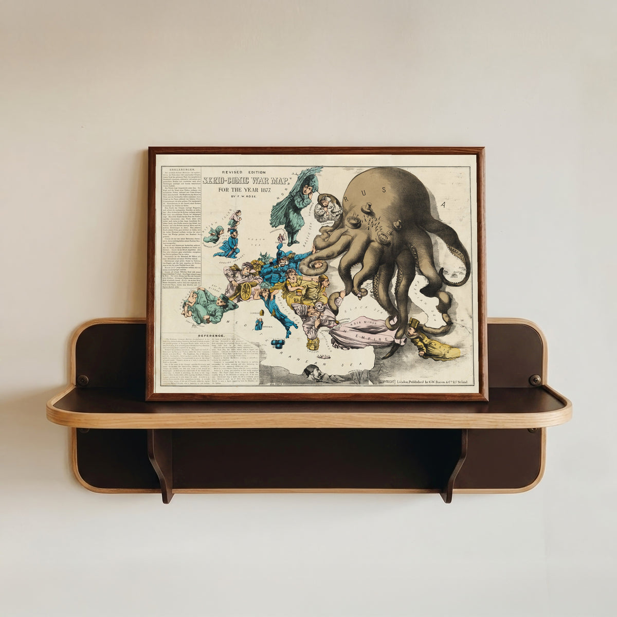 Framed art print of Serio-Comic War Map for the Year 1877 by Frederick W. Rose, in a dark wood frame resting on a wall shelf