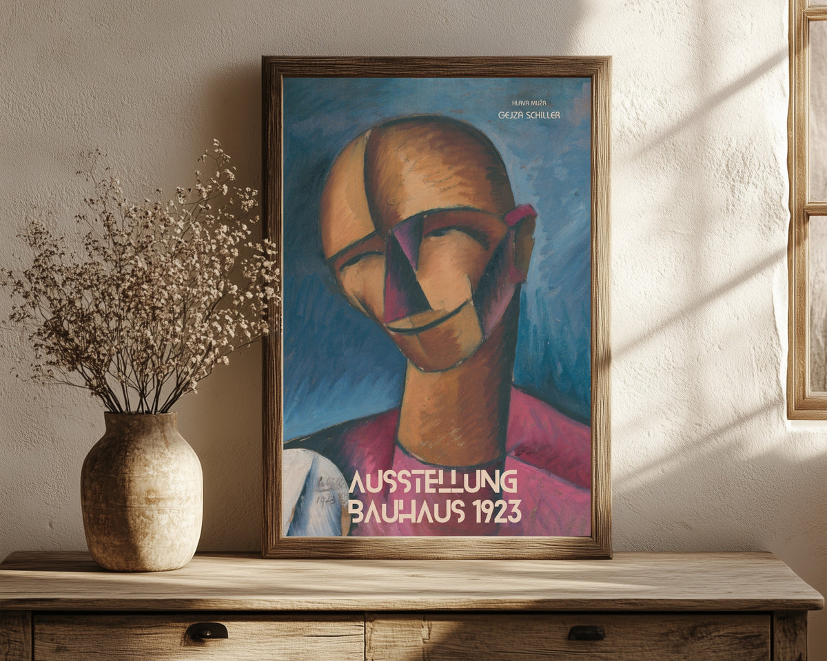 Framed art print of Hlava Muža by Gejza Schiller, in a dark wood frame leaning on a rustic console beside dried flowers