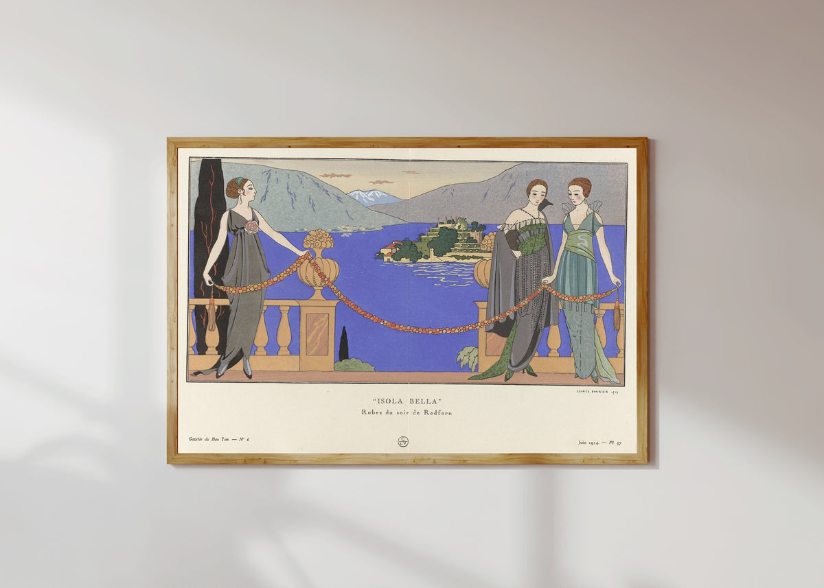 Framed art print of Isola Bella, robes du soir de Redfern by George Barbier, in a light wood frame on a sunlit white wall