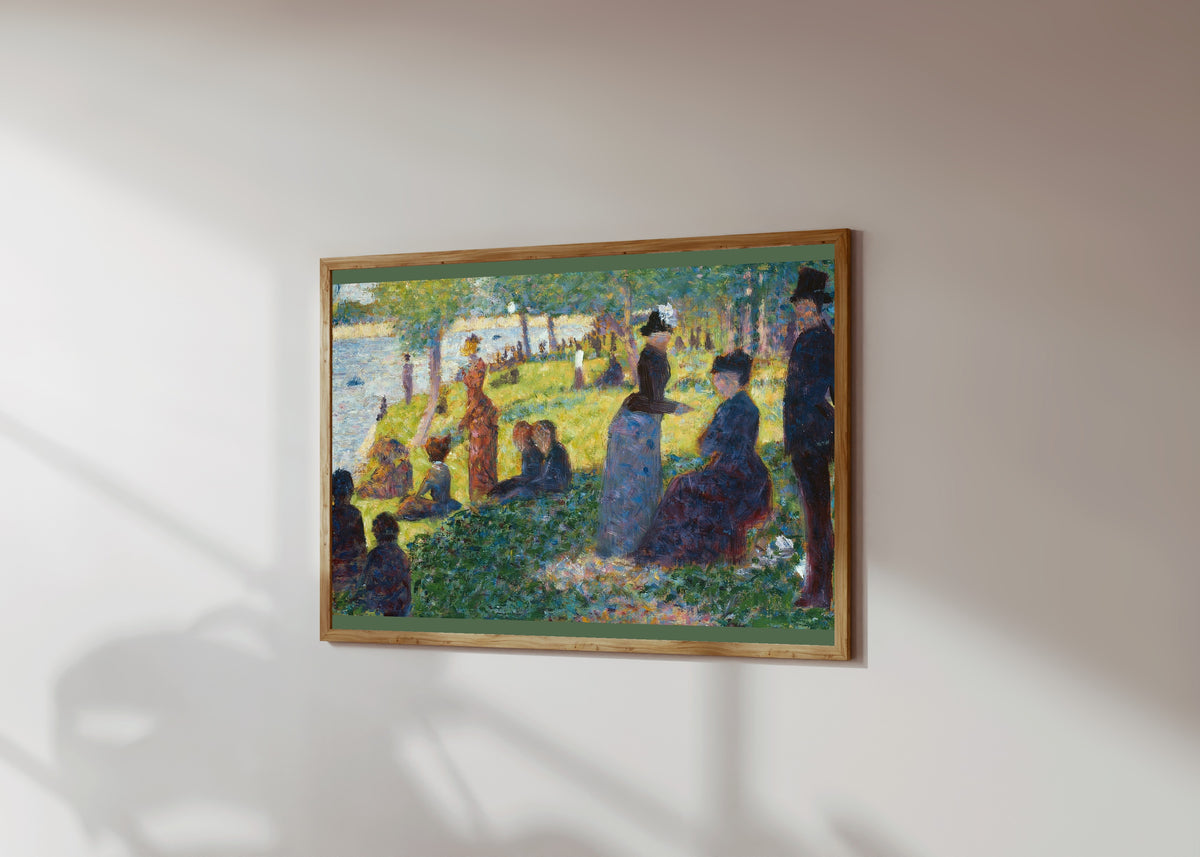 Framed art print of Oil Sketch for A Sunday on La Grande Jatte by Georges Seurat, in a light wood frame on a sunlit white wall, seen at a slight angle