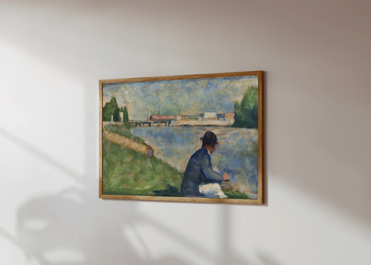 Framed art print of Study for "Bathers at Asnières" by Georges Seurat, in a light wood frame on a sunlit white wall, seen at a slight angle