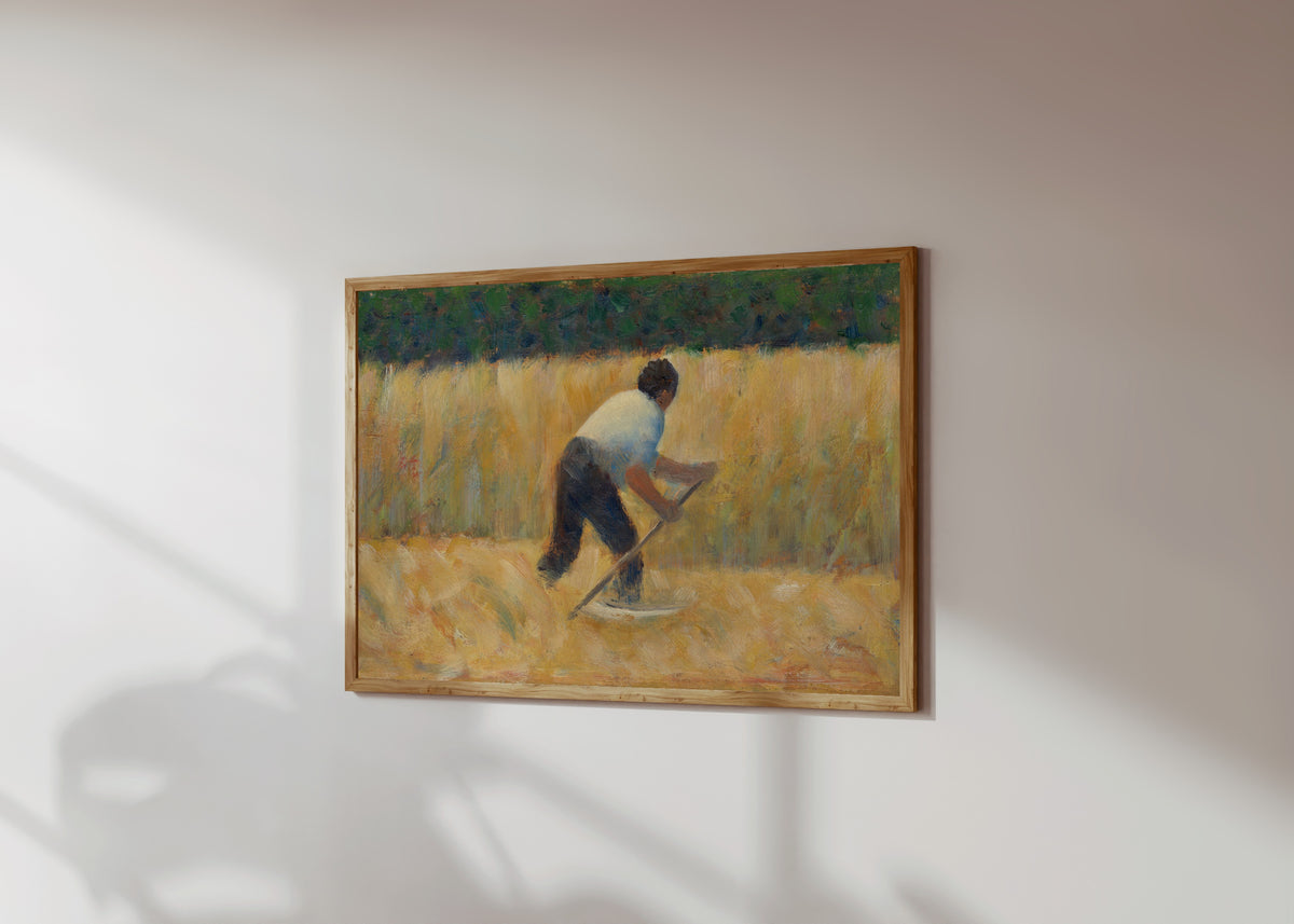 Framed art print of The Mower by Georges Seurat, in a light wood frame on a sunlit white wall, seen at a slight angle