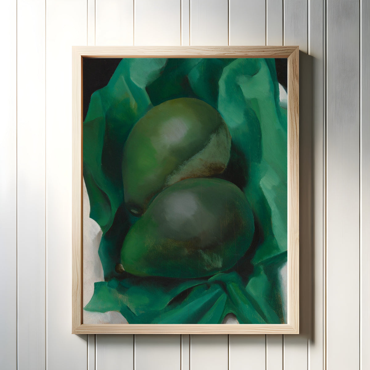 Framed art print of Alligator Pears by Georgia O'Keeffe, in a light wood frame on a white panelled wall