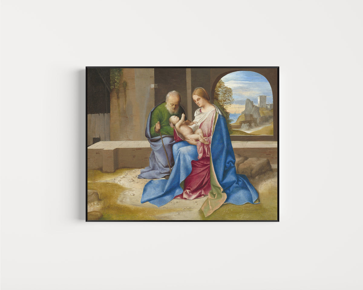 Framed art print of The Holy Family by Giorgione, in a slim black frame on a plain white wall