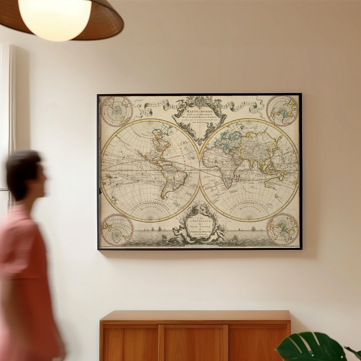 Framed art print of Mappe-Monde by Guillaume Delisle, in a slim black frame on a warm wall in a sunlit room