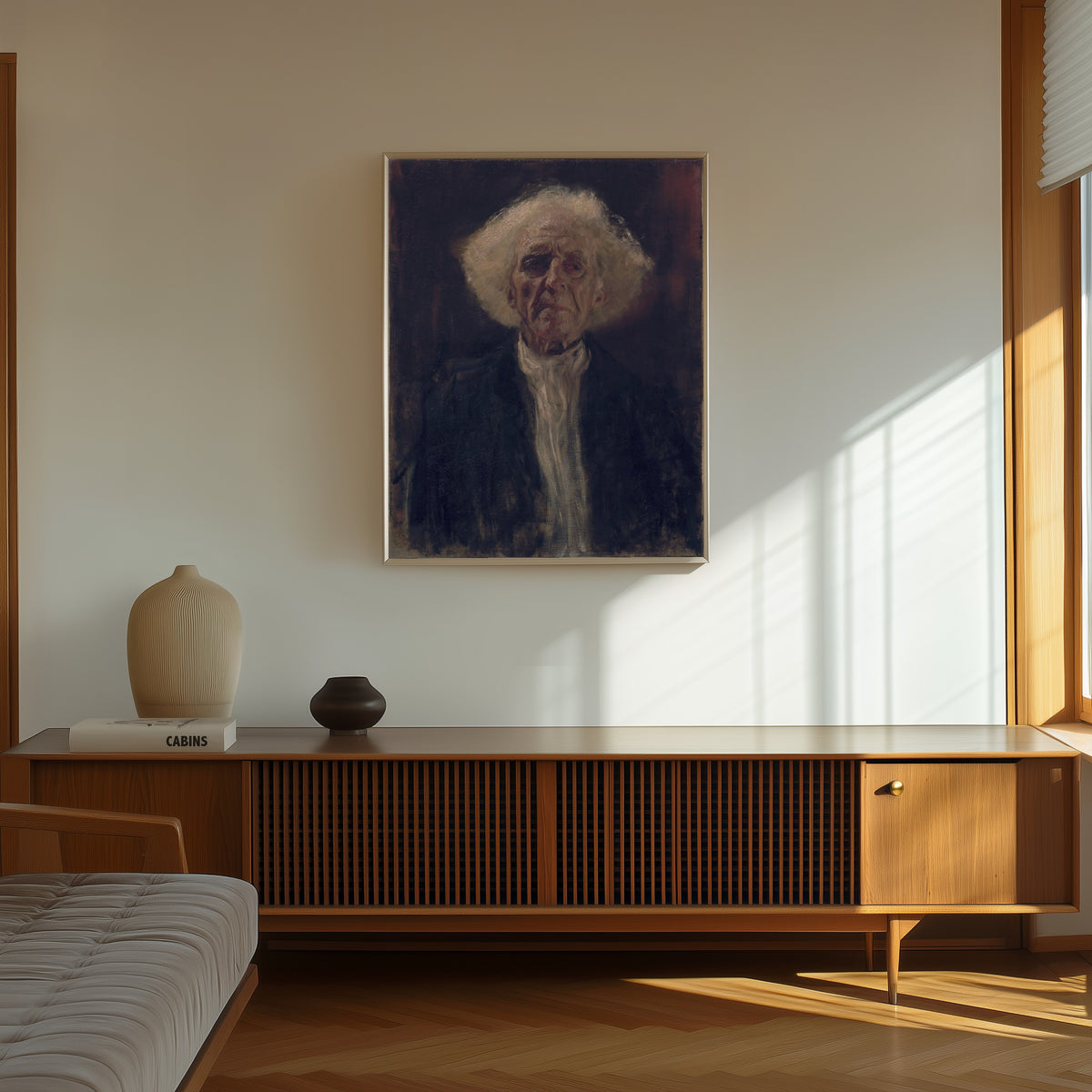 Framed art print of Blind Man by Gustav Klimt, in a thin light frame on a sunlit wall above a wooden sideboard