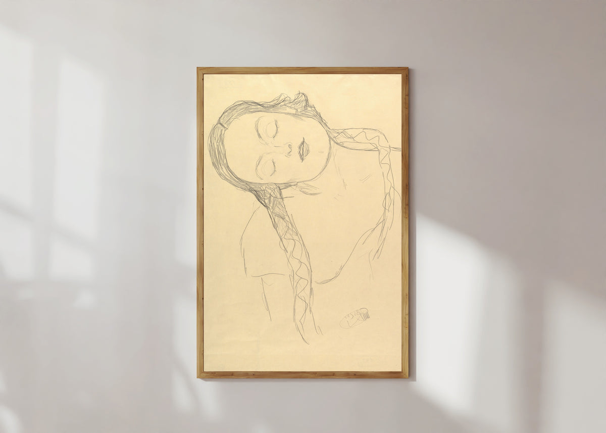 Framed art print of Half-figure of a Young Woman by Gustav Klimt, in a light wood frame on a sunlit white wall