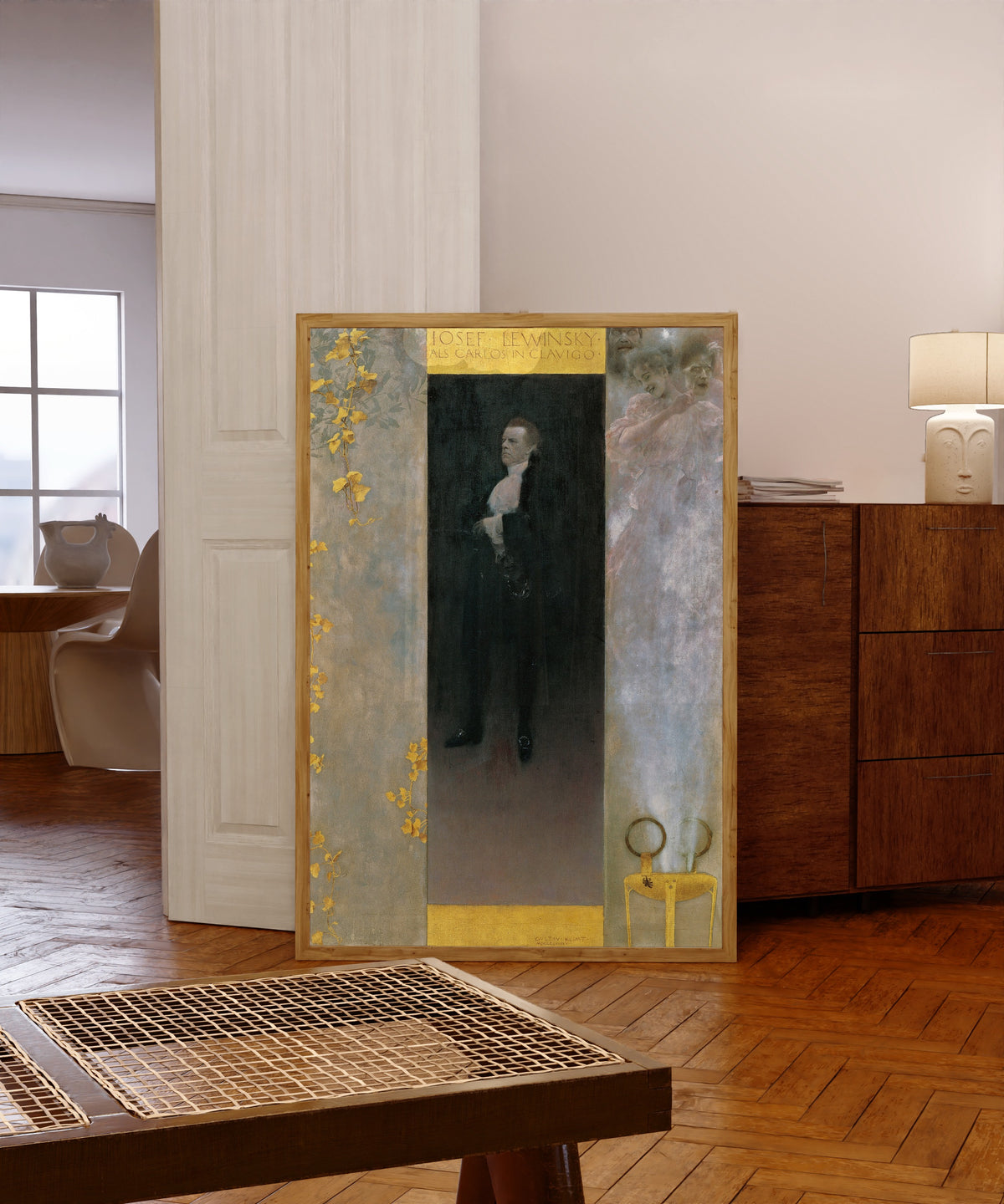 Framed art print of Josef Lewinsky as Carlos in Clavigo by Gustav Klimt, in a light wood frame leaning in a warm room with a parquet floor