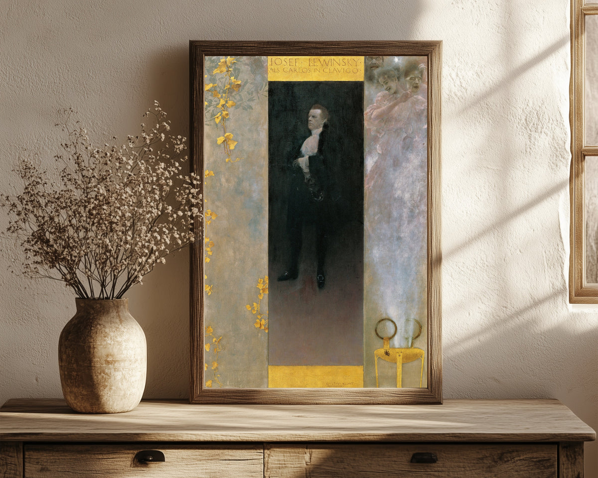Framed art print of Josef Lewinsky as Carlos in Clavigo by Gustav Klimt, in a dark wood frame leaning on a rustic console beside dried flowers