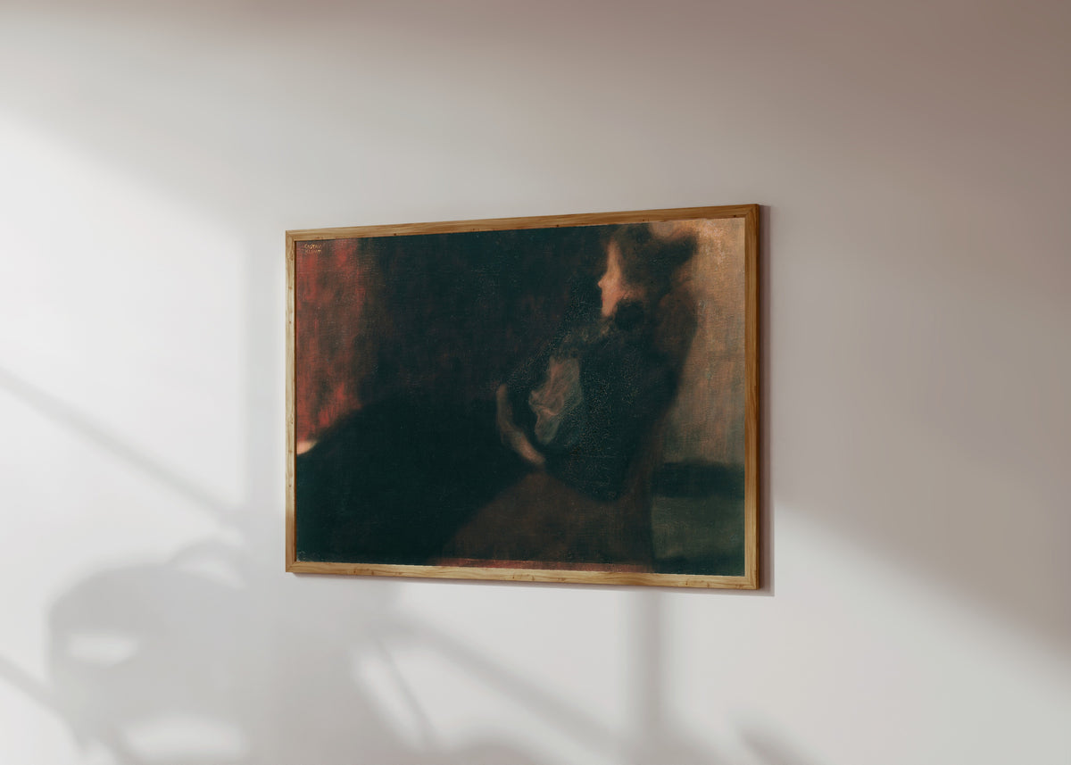 Framed art print of Lady by the Fireplace (Dame am Kamin) by Gustav Klimt, in a light wood frame on a sunlit white wall, seen at a slight angle